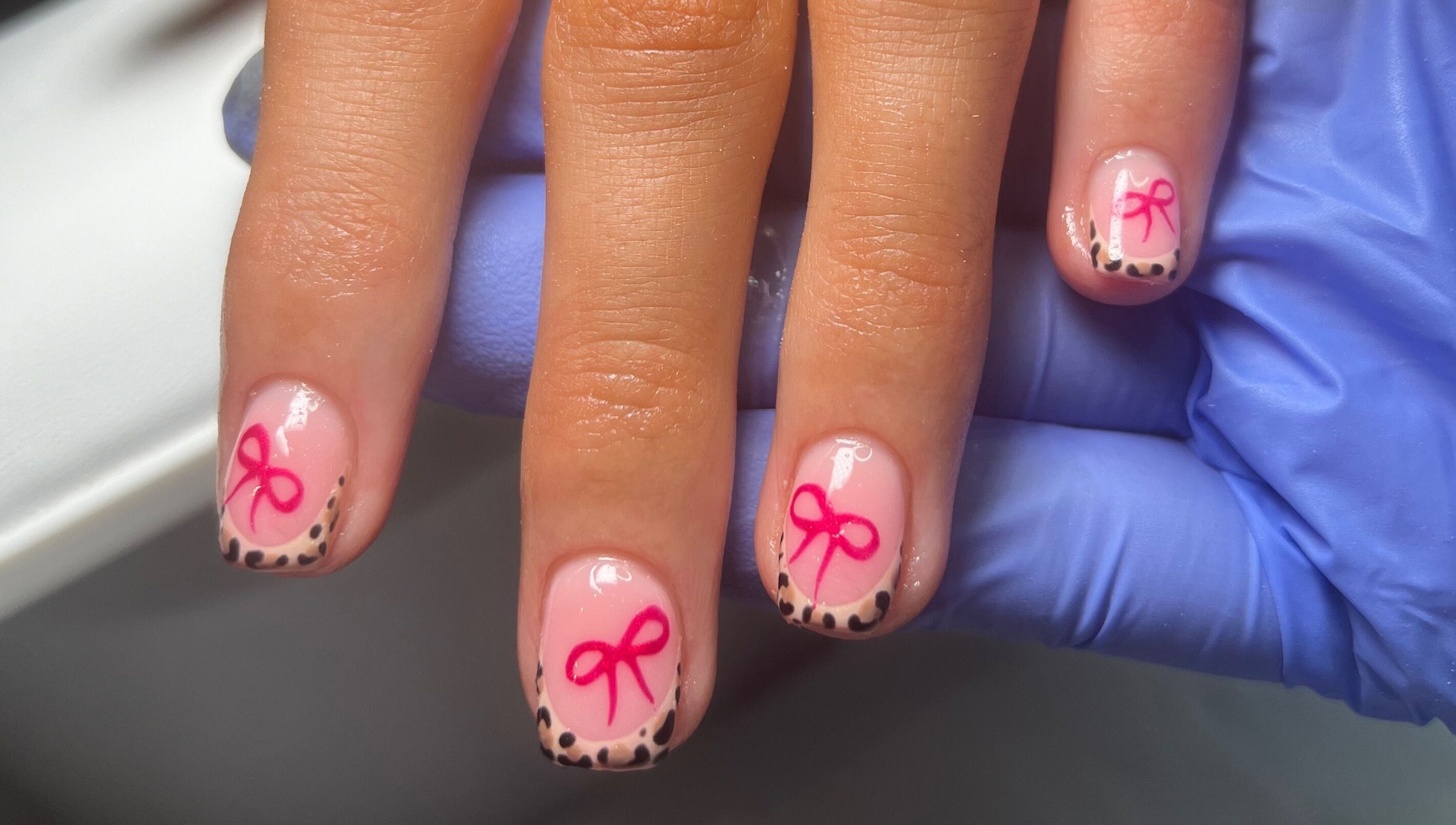 Styled nails with pink bows and leopard tips at Becca Kate Nails, Castlederg, Northern Ireland, GB.