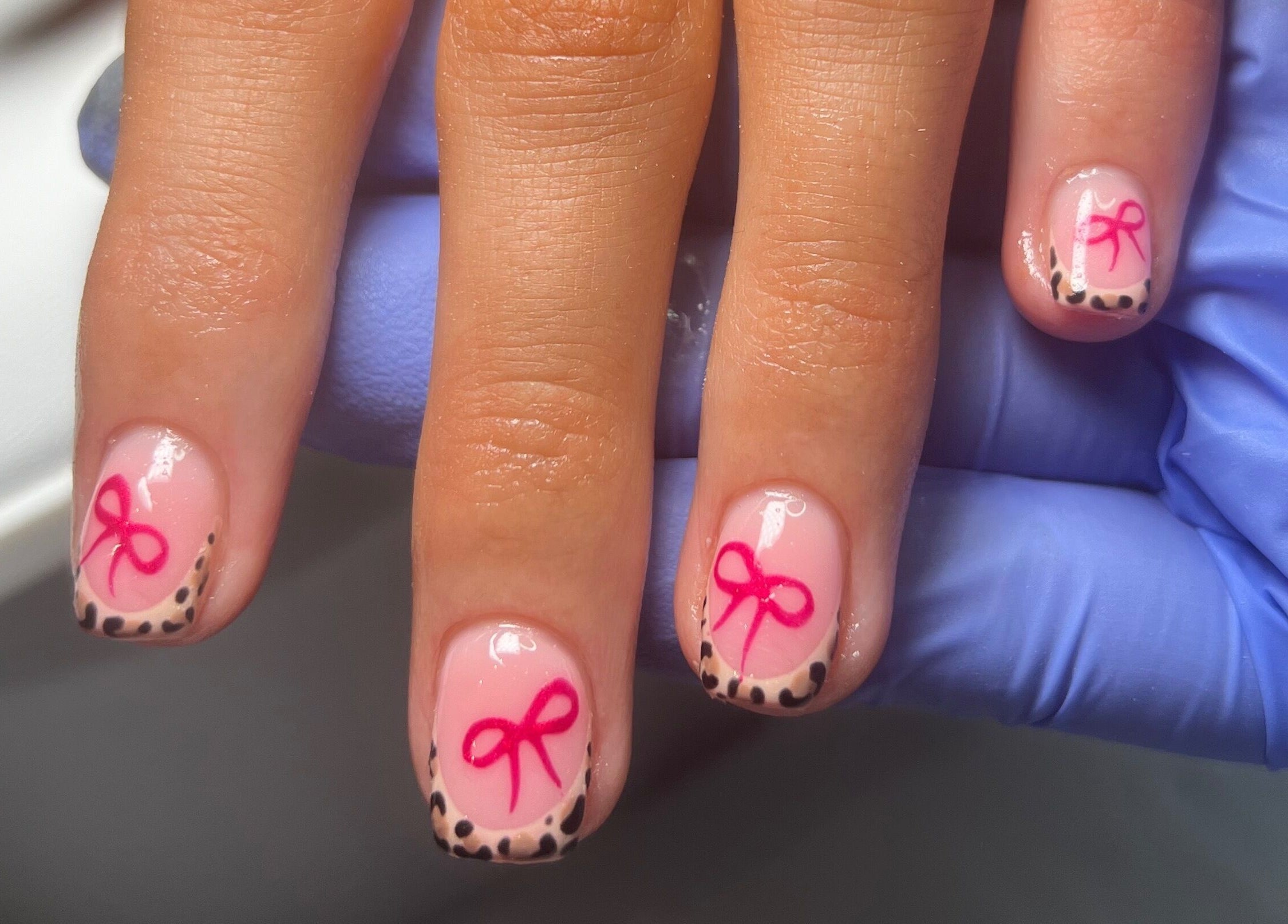 Styled nails with pink bows and leopard tips at Becca Kate Nails, Castlederg, Northern Ireland, GB.