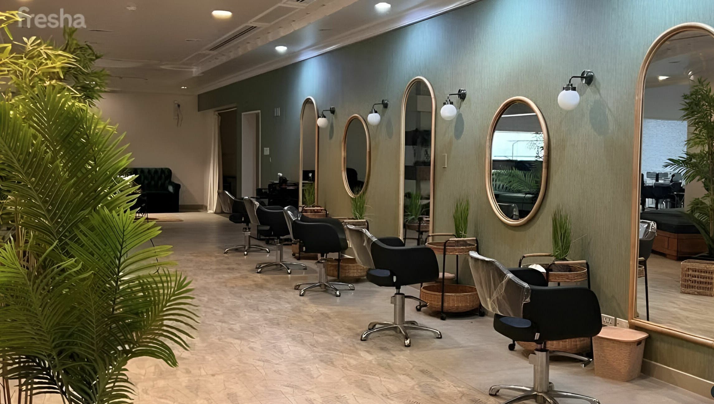 Interior of Last Touch Salon in Dammam, Eastern Province, SA with stylish chairs and greenery.