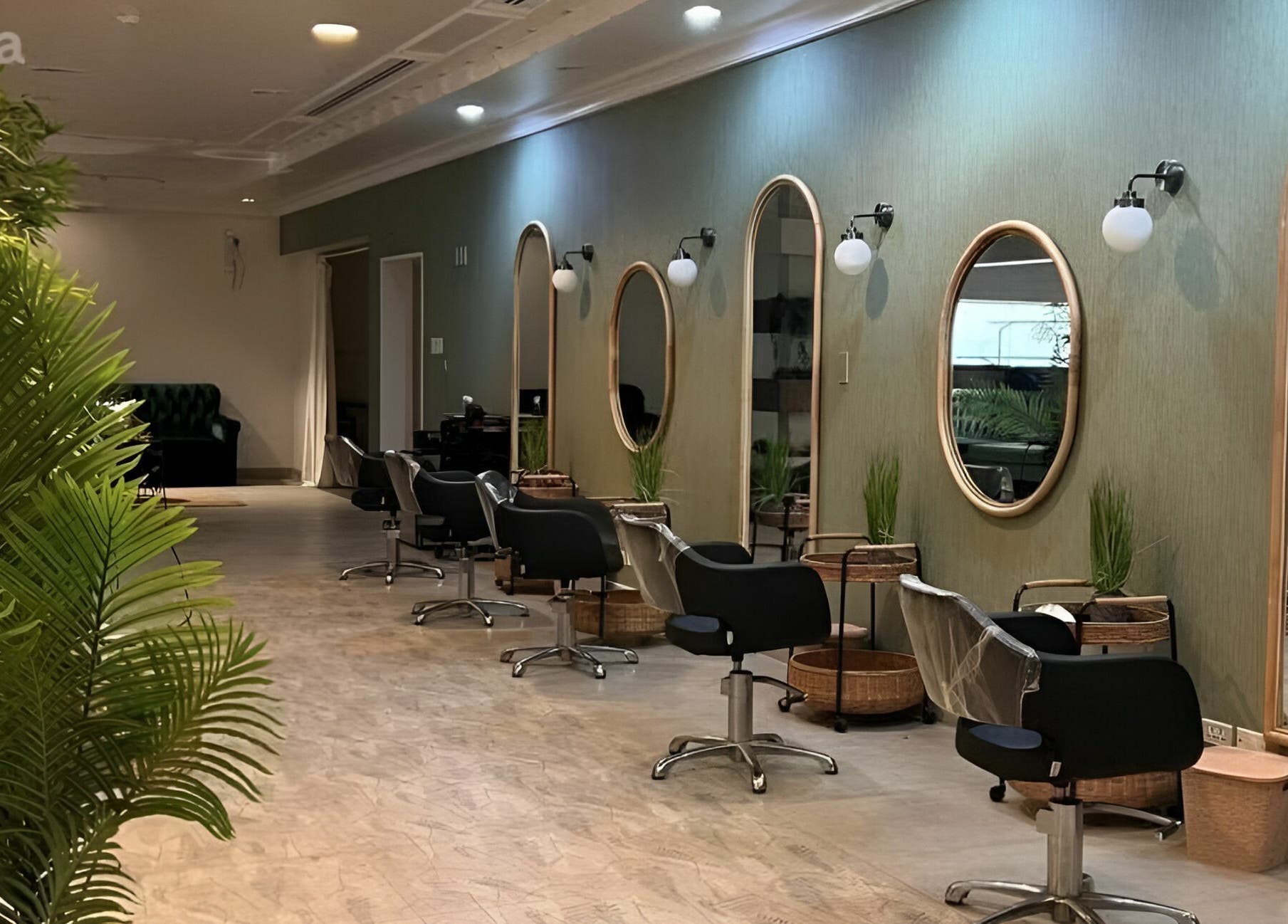 Interior of Last Touch Salon in Dammam, Eastern Province, SA with stylish chairs and greenery.