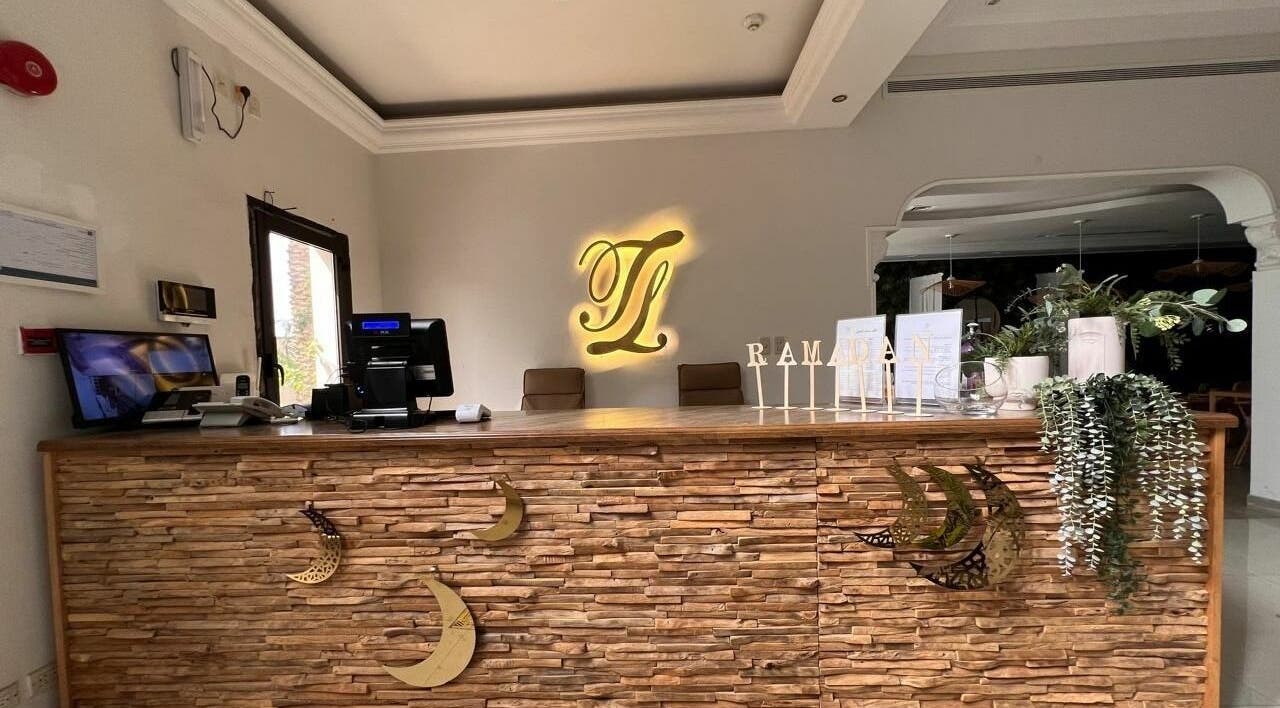 Reception at Last Touch Salon, Dammam, Eastern Province, SA with decorative stone counter and plants.