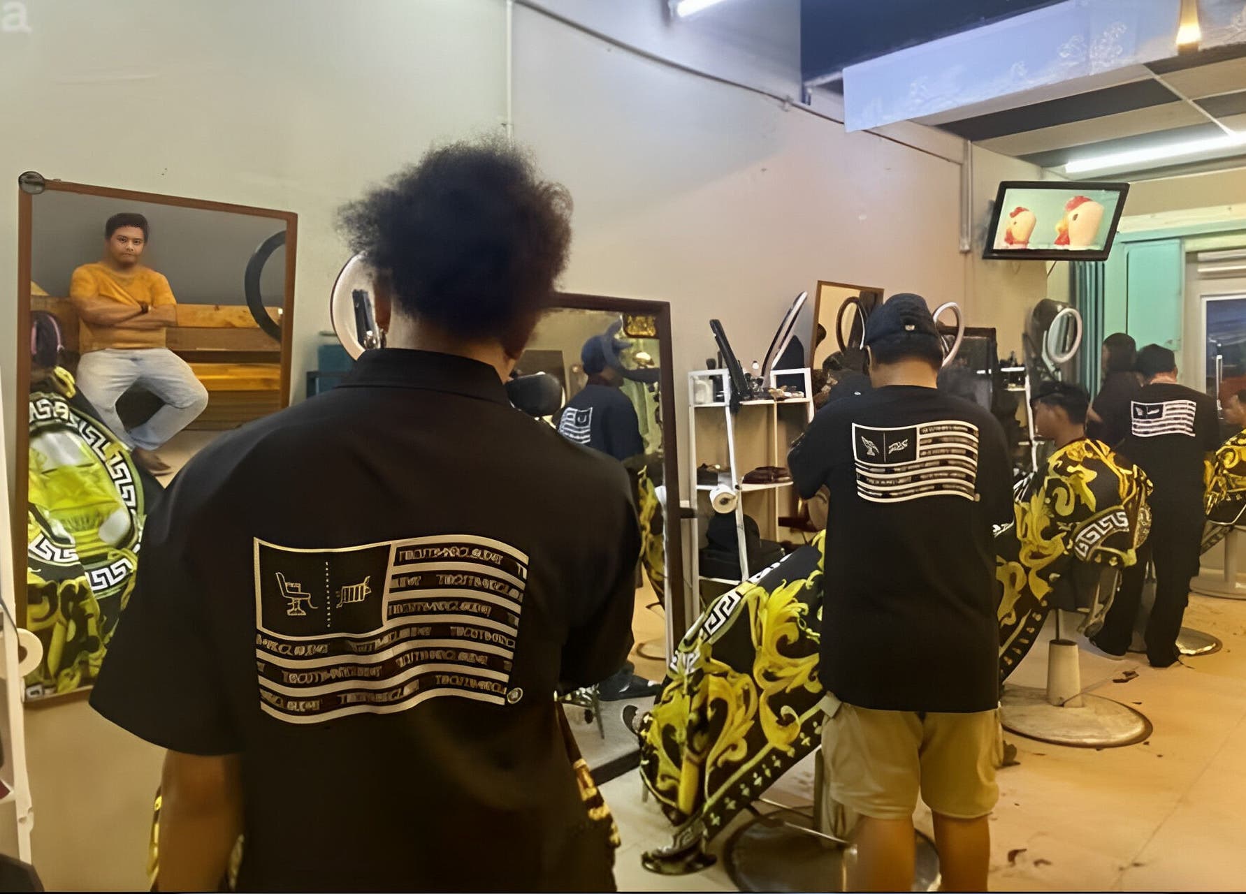 Barbers at Cuts & Cloud Damai in Pontian, Johor, MY, working with clients in a stylish, modern setting.