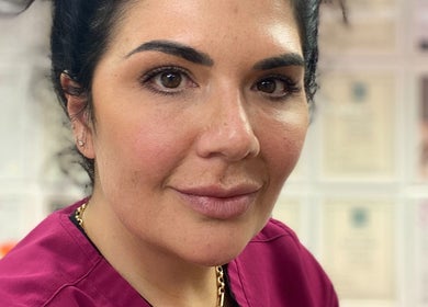Beauty expert at The London Dolls Aesthetics, London, England, GB, ready for transformative treatments.