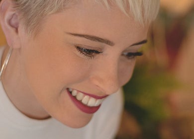 Close-up of a smiling person at The London Dolls Aesthetics, London, England, GB showcasing a makeup look.