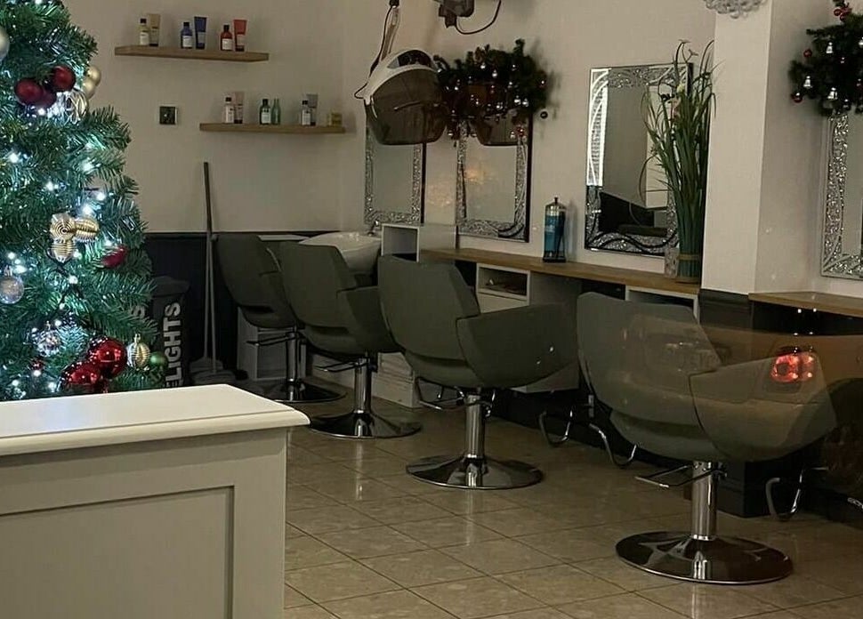 Corner Hairdressing in Lindfield, England, GB, decorated with a Christmas tree next to salon chairs and mirrors.