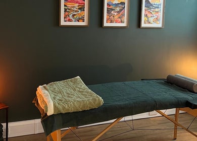 Cozy massage room at Nourish Holistic Therapy, Milton Keynes, England, GB with calming lighting and decor.