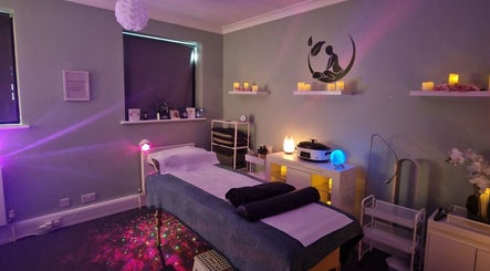Tranquil treatment room at Nourish Holistic Therapy, Milton Keynes, England, GB, with ambient lighting and decor.