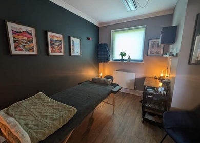 Cozy therapy room at Nourish Holistic Therapy in Milton Keynes, England, GB with art and candles.