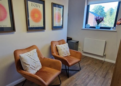 Cozy seating area with armchairs and decor at Nourish Holistic Therapy, Milton Keynes, England, GB.