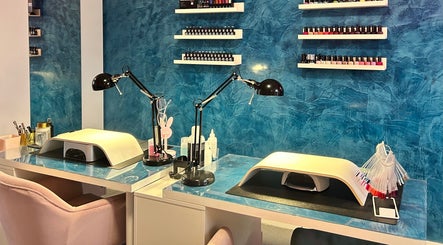 Chic nail station at Alexander Aromatics Wellness Studio in Dreghorn, Scotland, GB with vibrant blue walls.