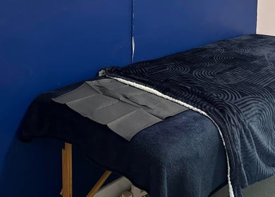 Cozy massage table at Alexander Aromatics Wellness Studio, Dreghorn, Scotland, GB for ultimate relaxation.