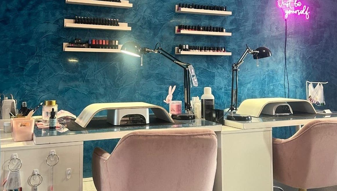 Nail station at Alexander Aromatics Wellness Studio, Girdle Toll, Scotland, GB with blue walls and stylish decor.