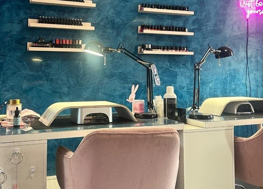 Nail station at Alexander Aromatics Wellness Studio, Girdle Toll, Scotland, GB with blue walls and stylish decor.