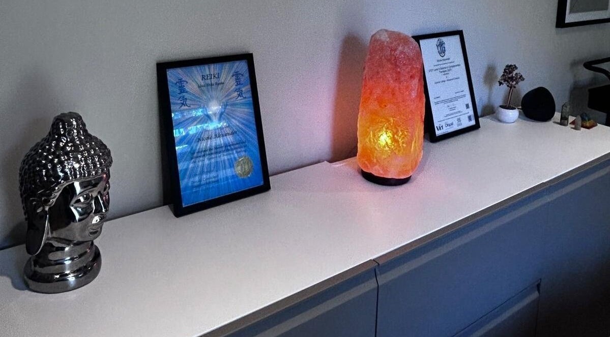 Decor at Alexander Aromatics Wellness Studio, Girdle Toll, Scotland. Buddha statue, salt lamp, and Reiki certificate.
