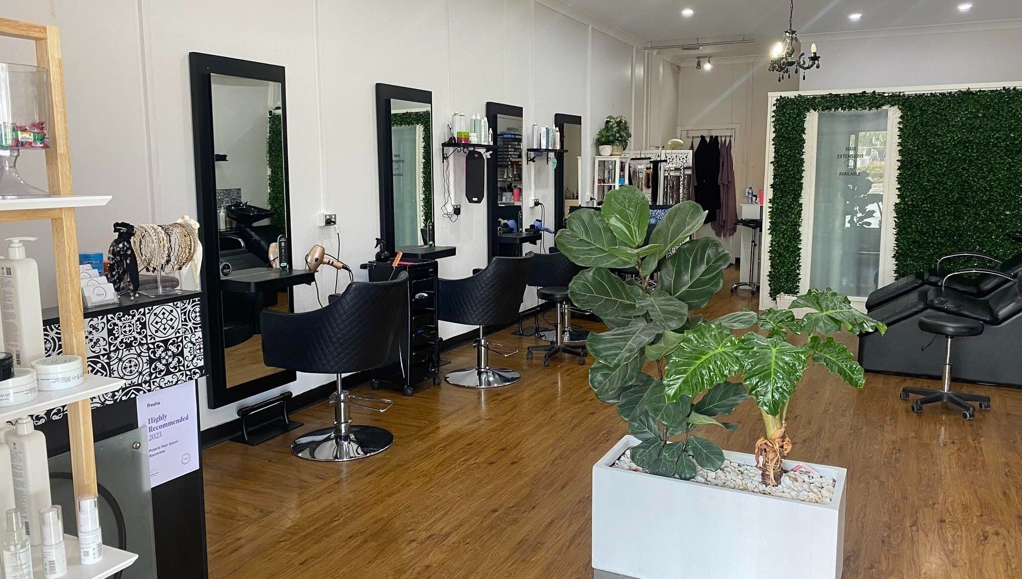 Interior of Polaris Hair Salon Raceview with stylish chairs and lush greenery in Raceview, Queensland, AU.