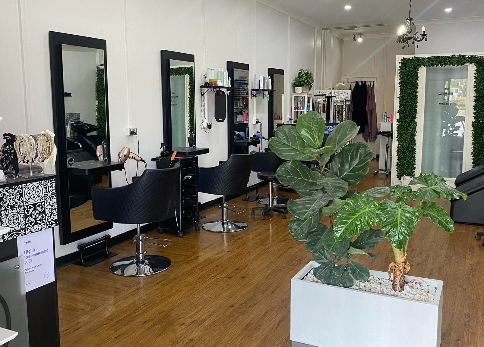 Interior of Polaris Hair Salon Raceview with stylish chairs and lush greenery in Raceview, Queensland, AU.