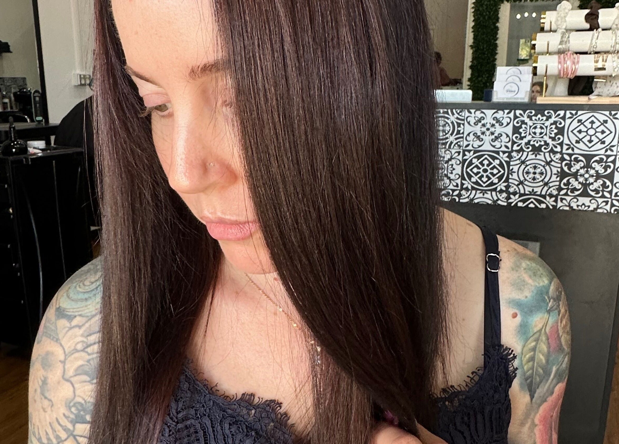 Woman with sleek hair at Polaris Hair Salon Raceview, showcasing stylish interior. Raceview, Queensland, AU.