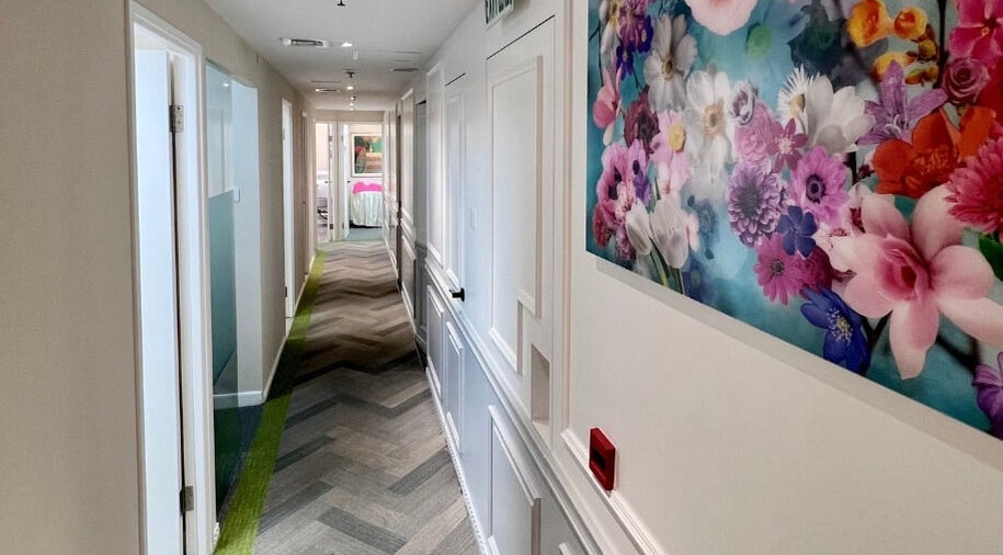 Bright hallway with floral artwork at Honeypot Wax Boutique (Central), Hong Kong Island, HK.