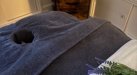 A cozy massage table setup in Chill Well-Being, Maidstone, England, GB with soft towels and lavender sprigs.