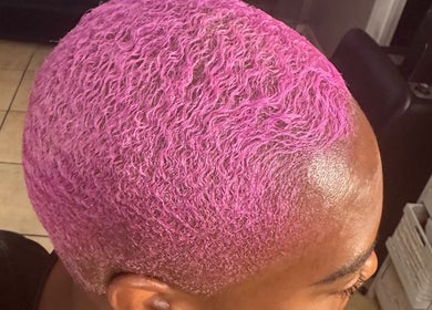 Vibrant pink curls styled at Passion Hair Solutions in Lanham, Maryland, US, showcasing unique hair color artistry.