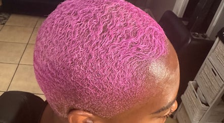 Vibrant pink curls styled at Passion Hair Solutions in Lanham, Maryland, US, showcasing unique hair color artistry.