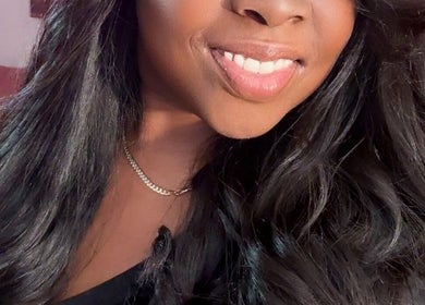 Smiling woman with sleek hair at Passion Hair Solutions, Lanham, Maryland, US.