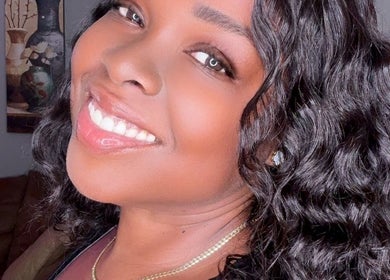 Smiling woman with curly hair at Passion Hair Solutions, Lanham, Maryland, US.