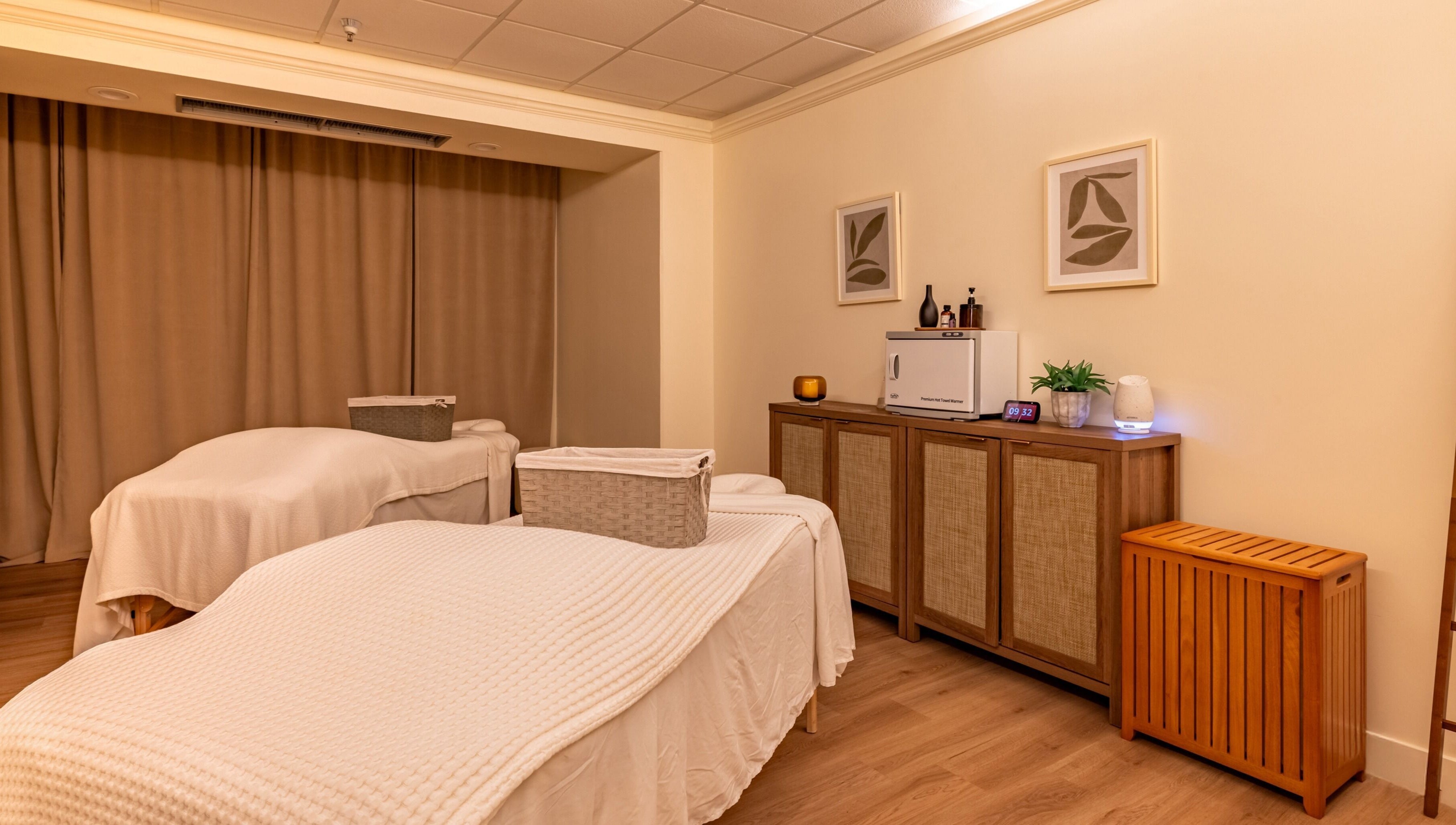 Calm treatment room at Asana Spa at Hilton Waikiki Beach, Honolulu, Hawaii, US, featuring massage tables and decor.