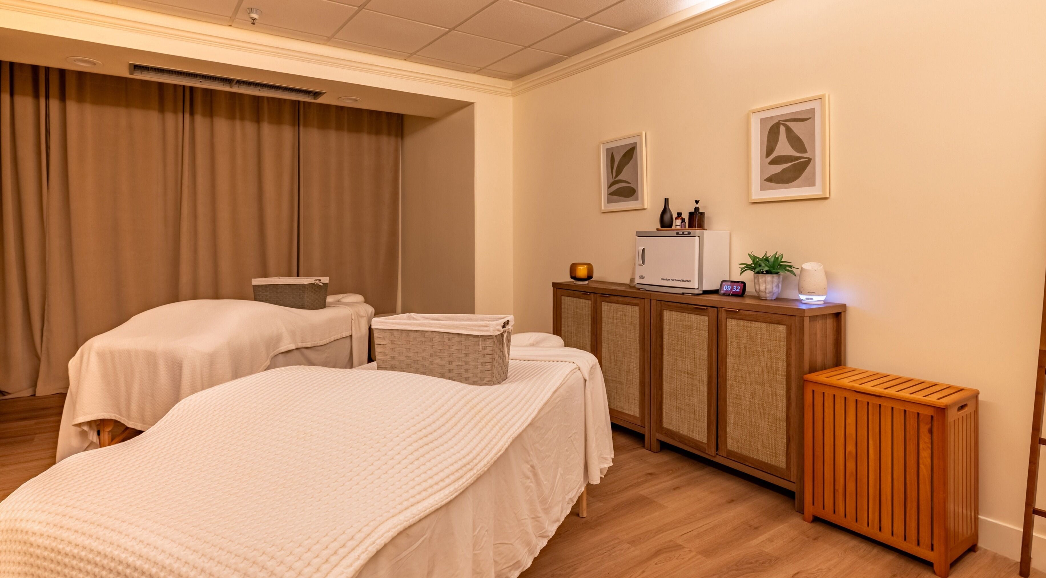 Calm treatment room at Asana Spa at Hilton Waikiki Beach, Honolulu, Hawaii, US, featuring massage tables and decor.