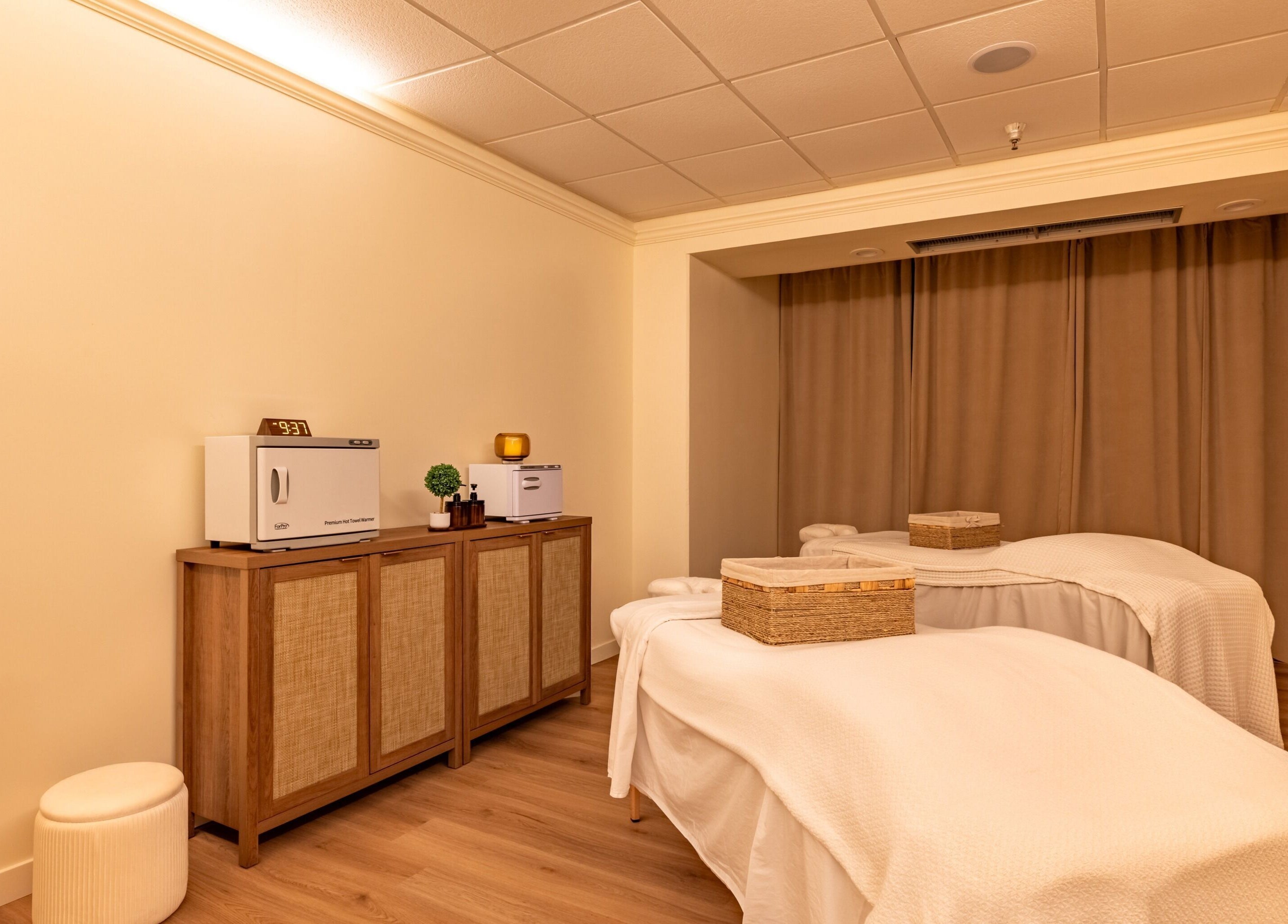 Relaxing massage room at Asana Spa at Hilton Waikiki Beach, Honolulu, Hawaii, US featuring twin beds.
