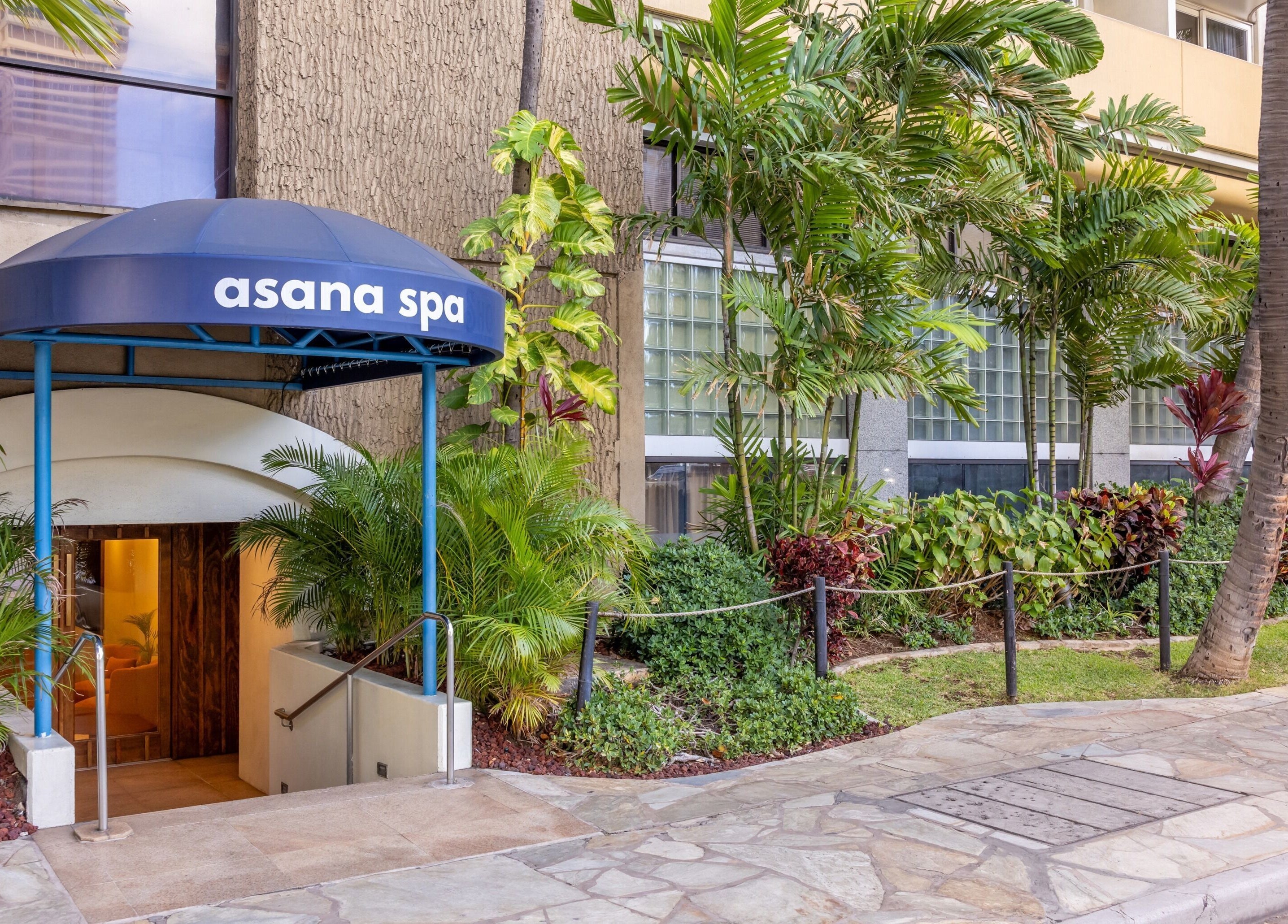 Entrance to Asana Spa at Hilton Waikiki Beach surrounded by lush greenery in Honolulu, Hawaii, US.