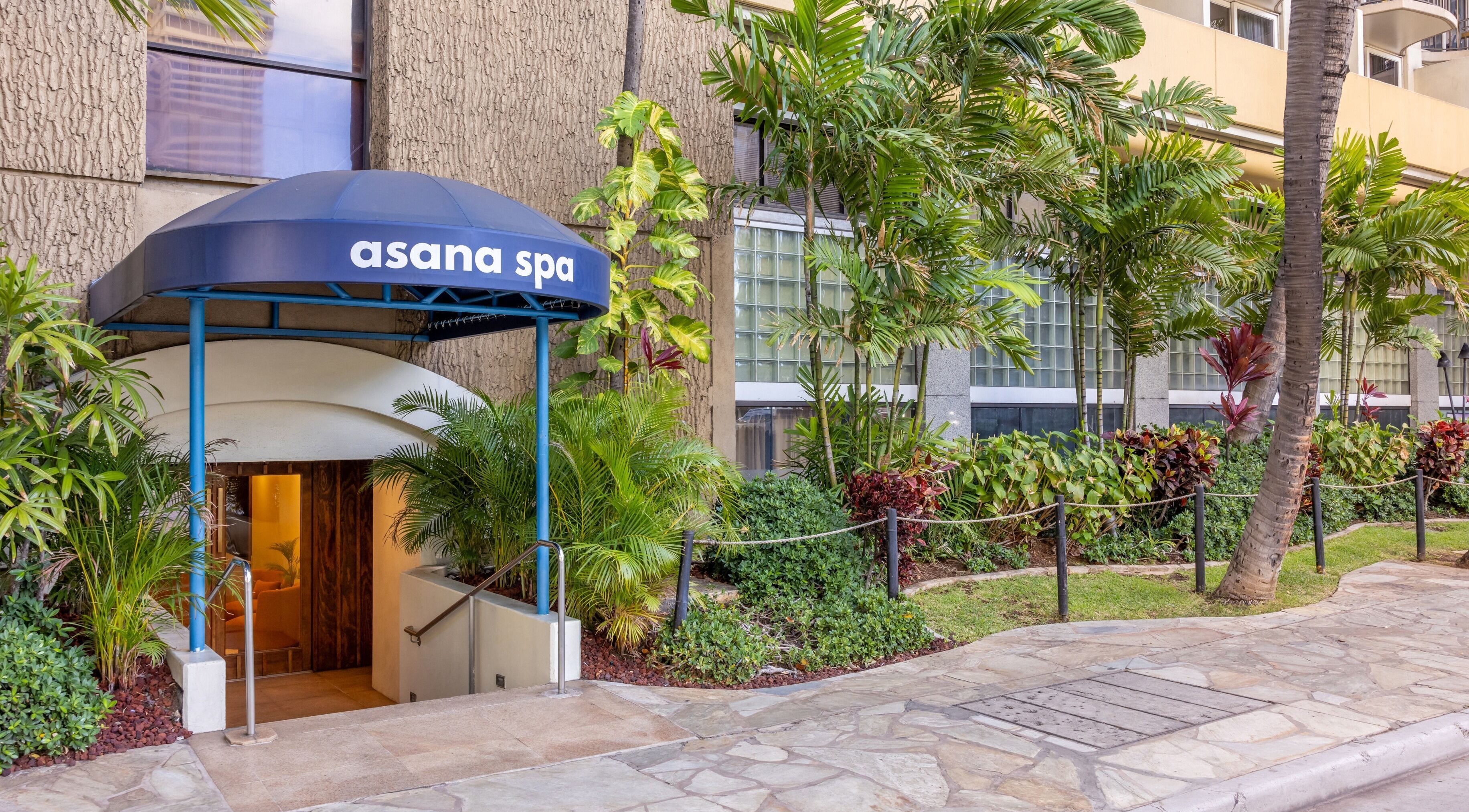 Entrance to Asana Spa at Hilton Waikiki Beach surrounded by lush greenery in Honolulu, Hawaii, US.