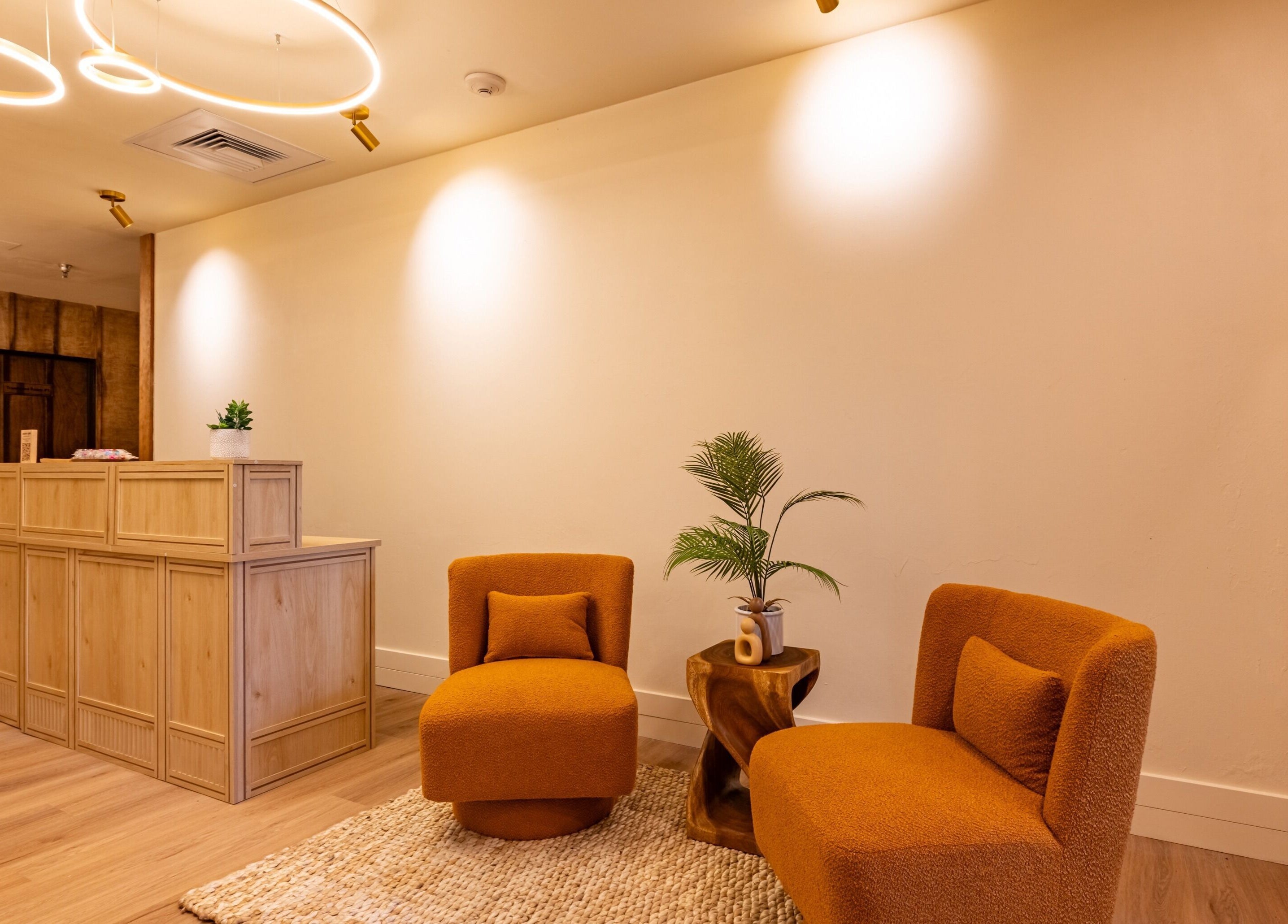 Cozy lobby at Asana Spa at Hilton Waikiki Beach in Honolulu, Hawaii, US with plush chairs and warm lighting.