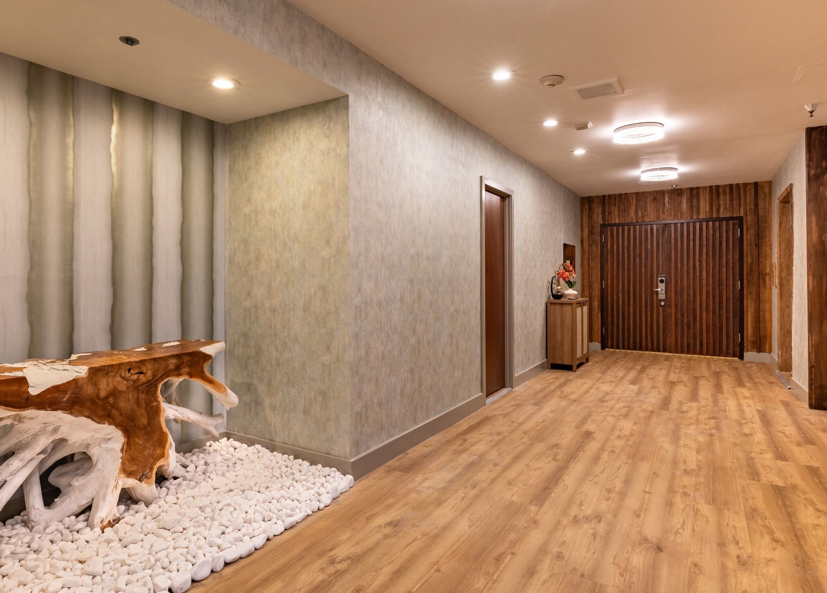 Elegant hallway at Asana Spa at Hilton Waikiki Beach, Honolulu, Hawaii, US featuring natural wood accents.