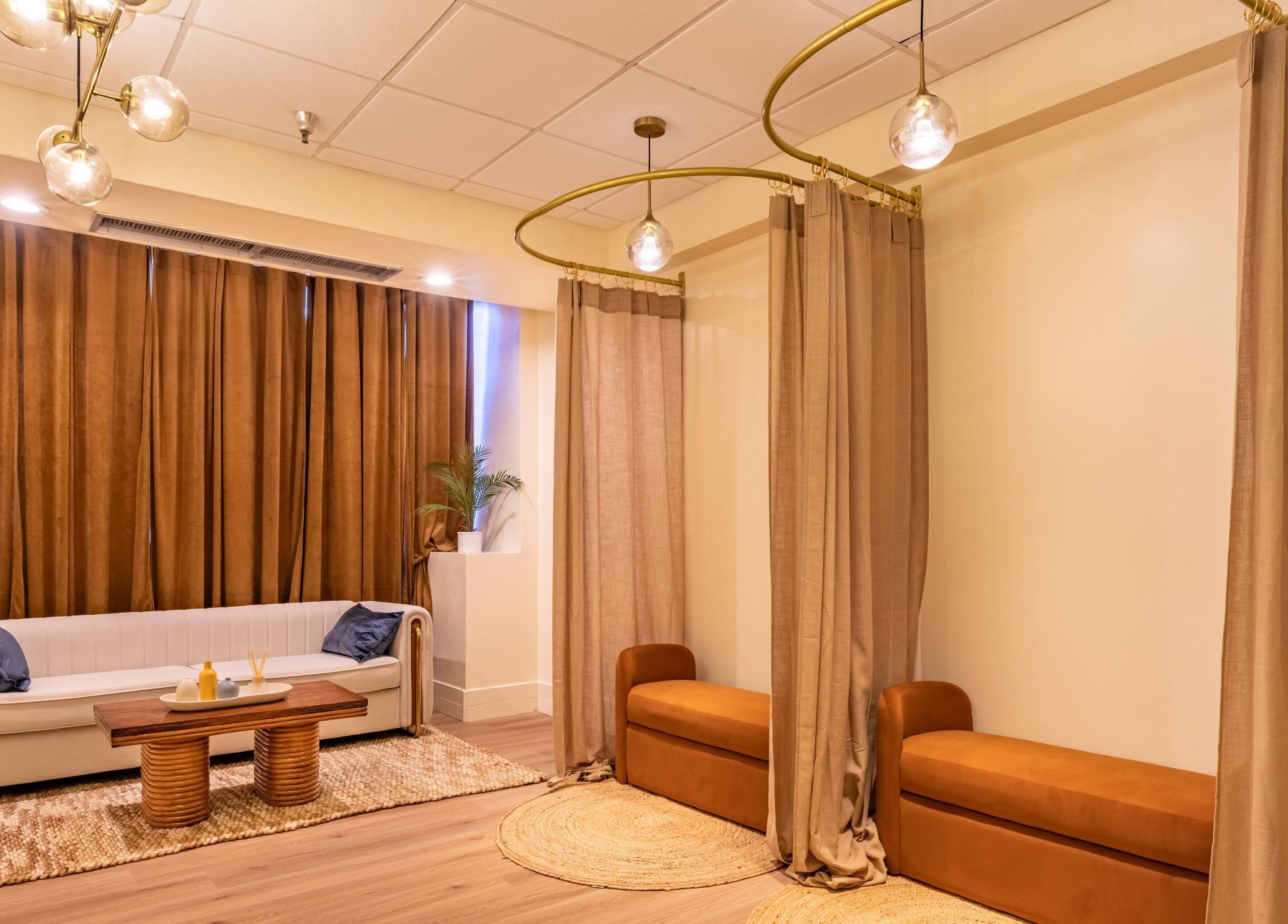 Relaxing lounge area at Asana Spa at Hilton Waikiki Beach, Honolulu, Hawaii, US, with cozy seating and warm decor.