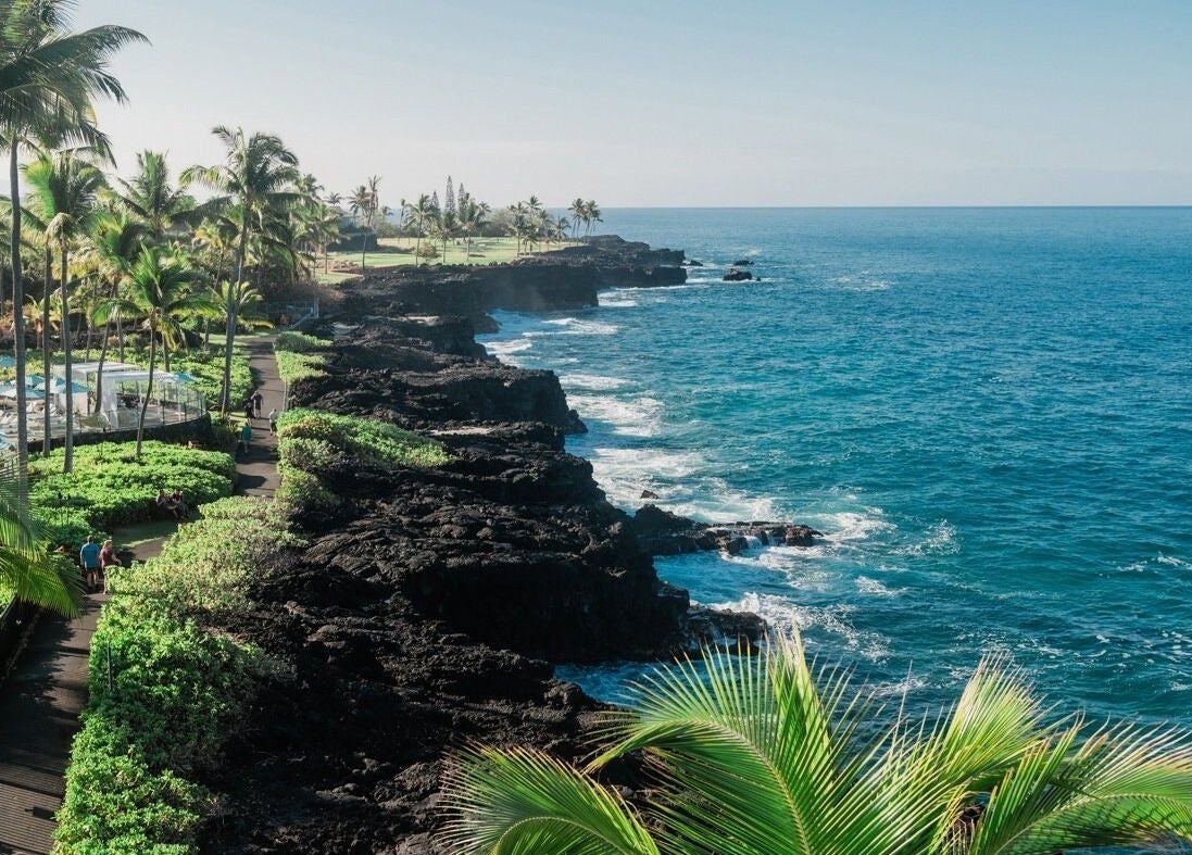Asana Spa at Outrigger Kona Resort's coastal view in Kailua-kona, Hawaii, US with lush greenery and blue waters.