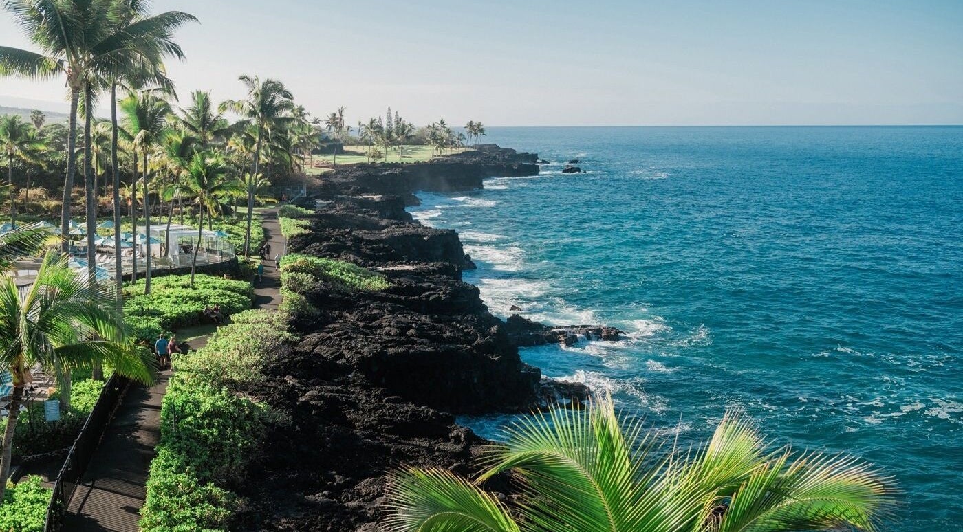 Asana Spa at Outrigger Kona Resort's coastal view in Kailua-kona, Hawaii, US with lush greenery and blue waters.