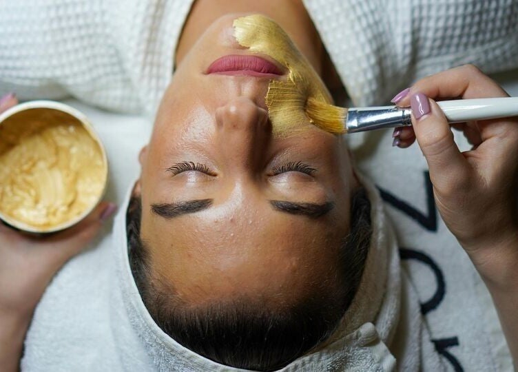 Facial treatment at Asana Spa at Outrigger Kona Resort, Kailua-kona, Hawaii, US, with golden mask application.