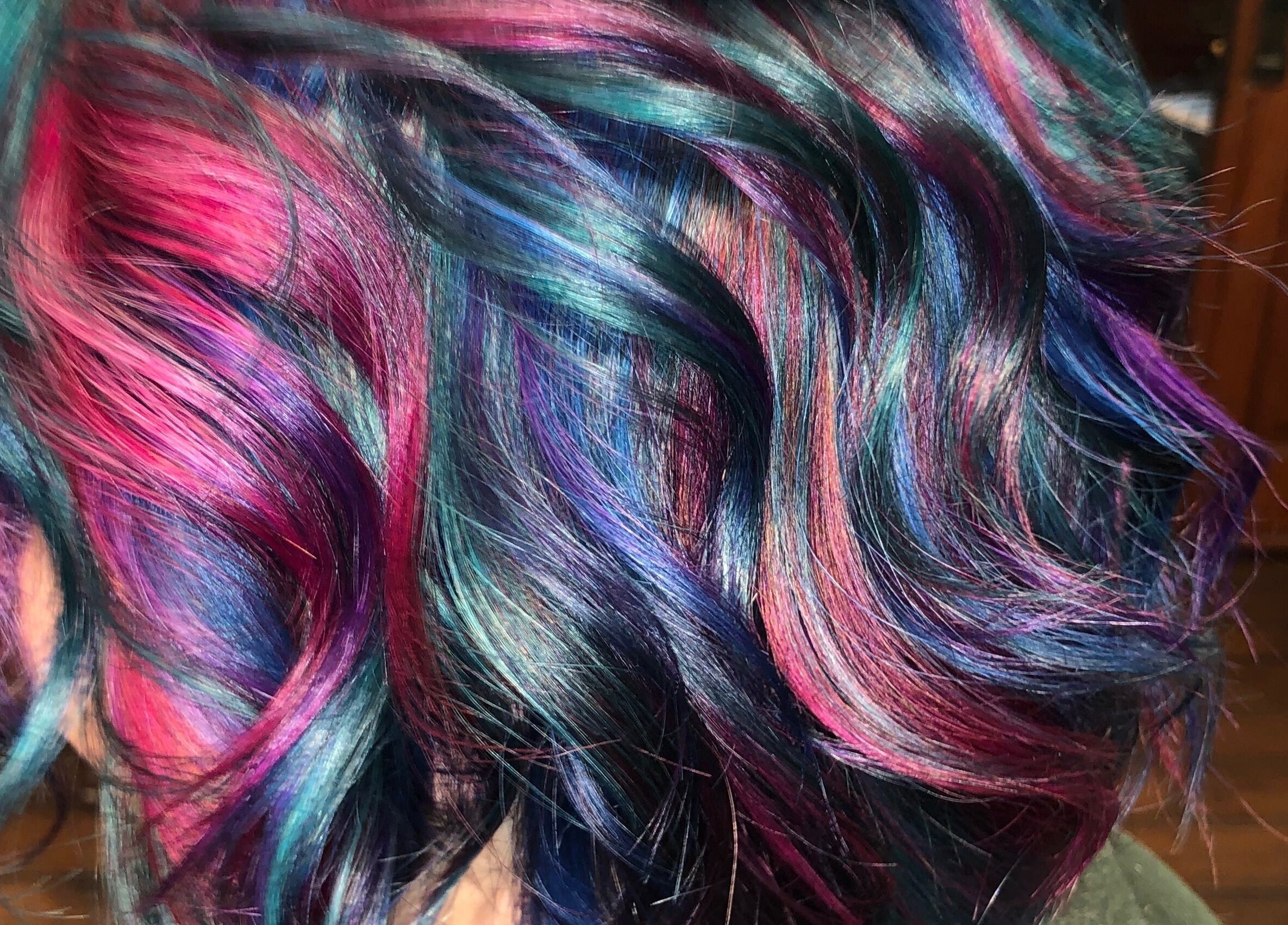 Colorful hair design at TKM Hair Design and Restorations in Reading, Pennsylvania, US showcasing vibrant curls.