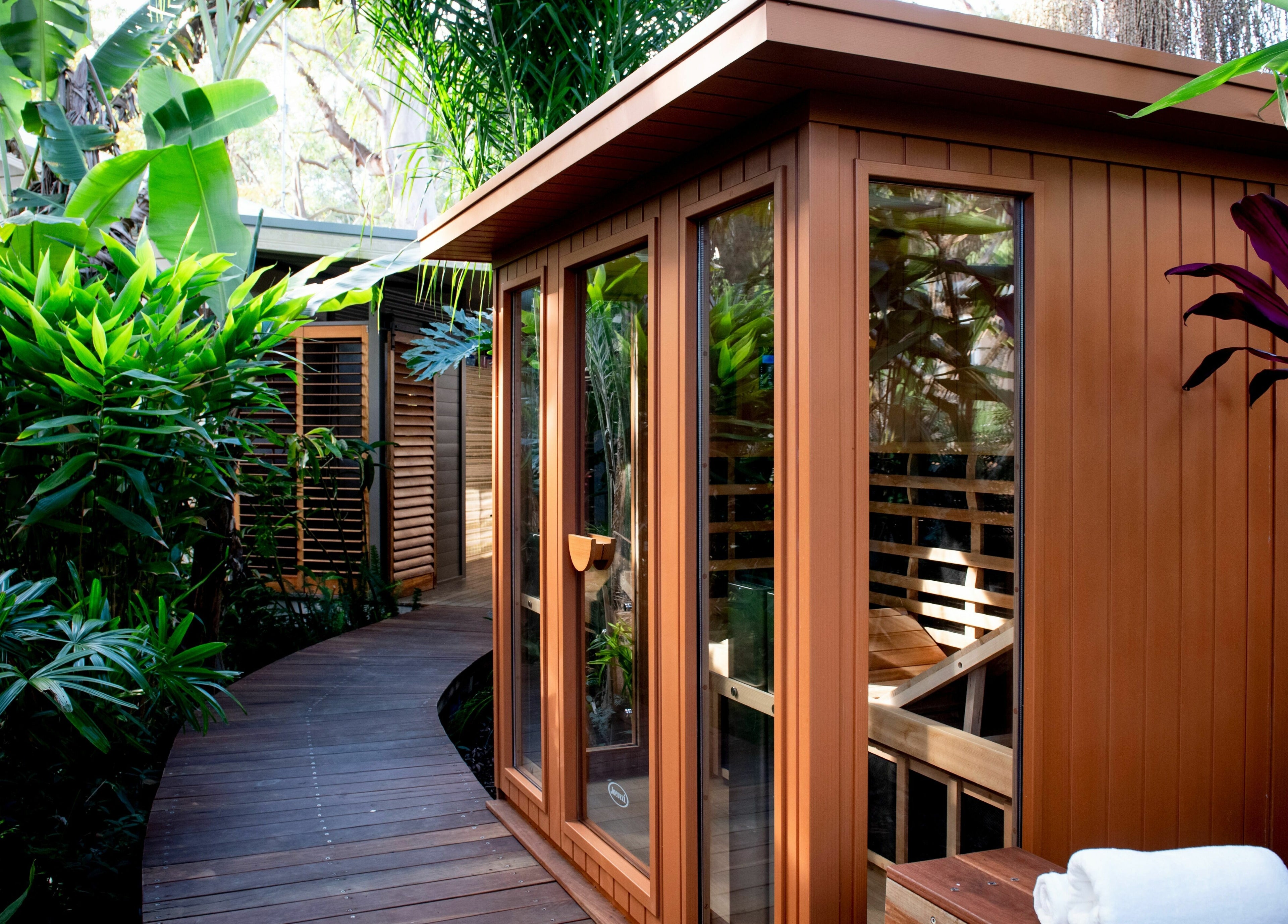 Lush greenery surrounds the tranquil sauna at Cloud 9 Sauna, Macmasters Beach, New South Wales, AU.
