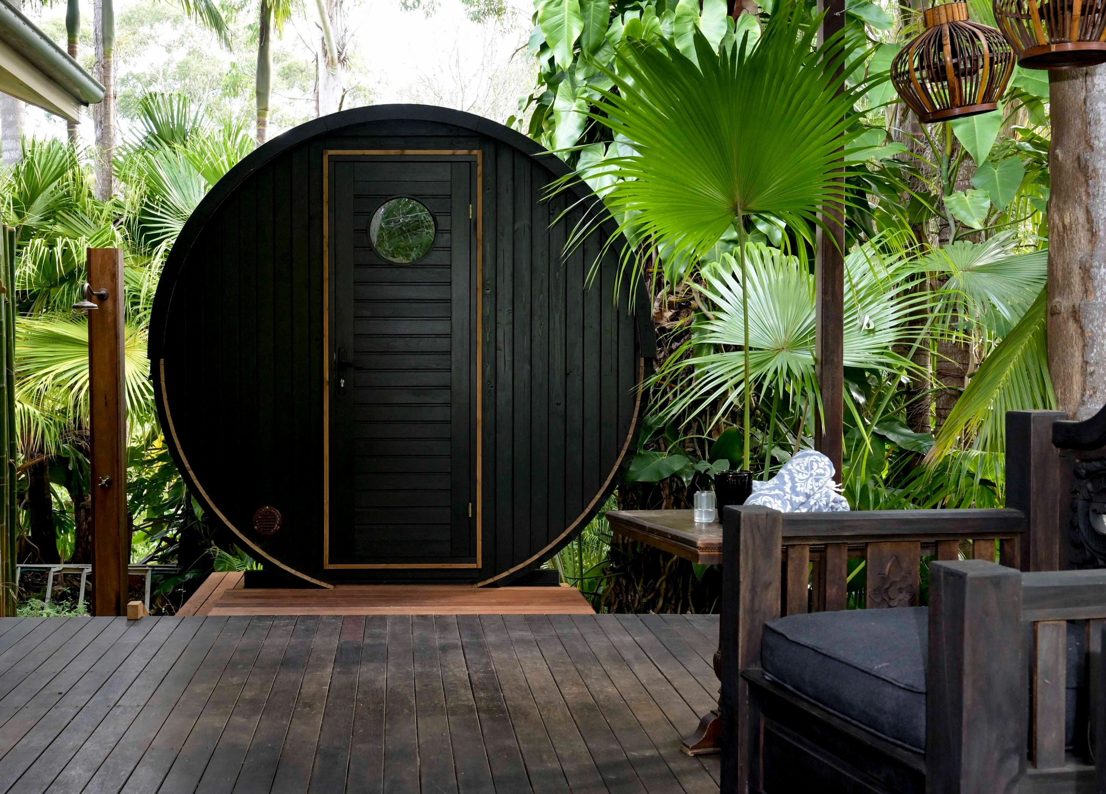 Serene outdoor sauna at Cloud 9 Sauna, Macmasters Beach, New South Wales, AU, surrounded by lush greenery.