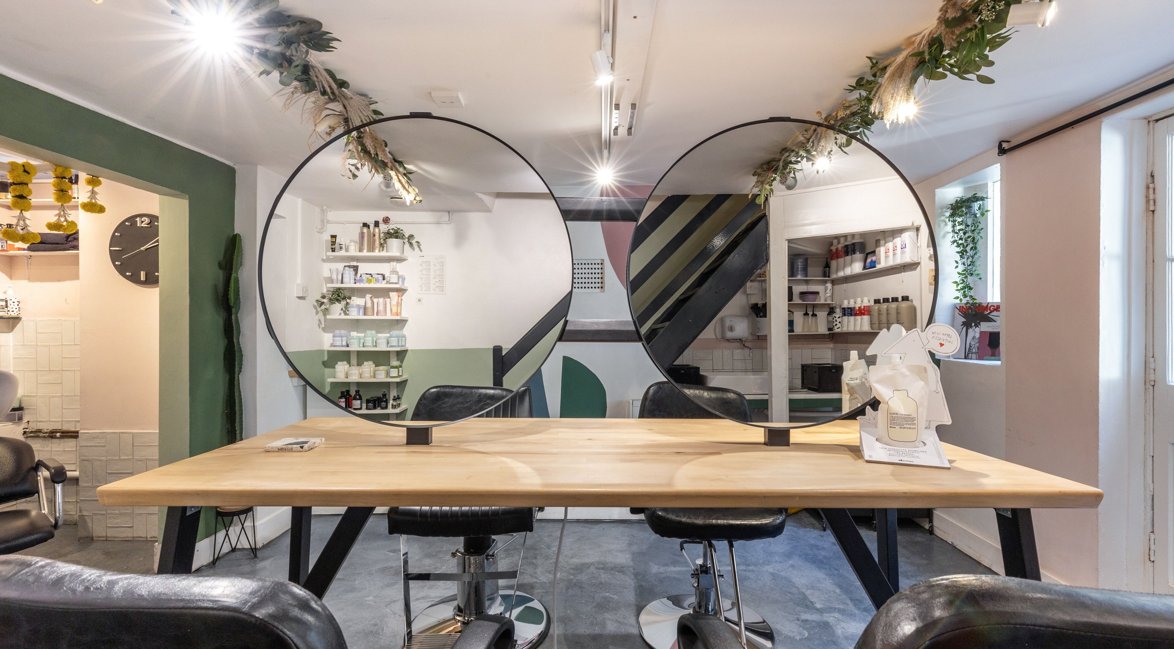 Modern salon interior at Haven Hair Hackney in London, England, GB with chic decor and ample natural light.