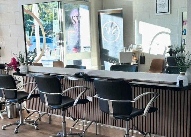 Modern salon at SV Hair Design in Gladstone Central, Queensland, AU with stylish seating and hair products.