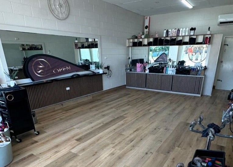 Modern interior of SV Hair Design in Gladstone Central, Queensland, AU, showcasing stylish décor and mirrors.