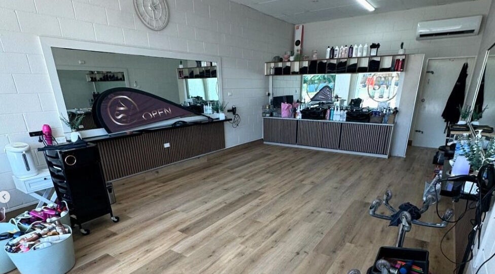 Modern interior of SV Hair Design in Gladstone Central, Queensland, AU, showcasing stylish décor and mirrors.