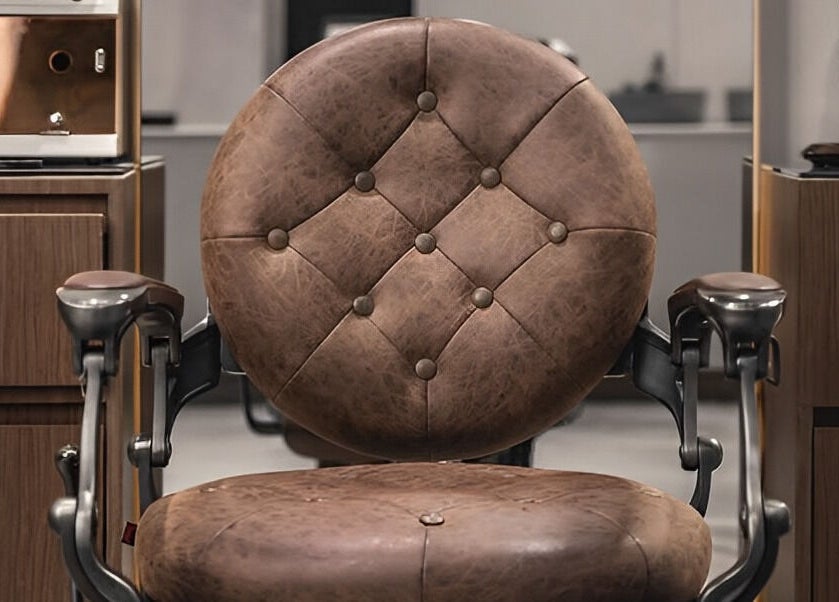 Luxurious leather barber chair at Scissors & Razors in Dubai, AE, offering comfort and style.