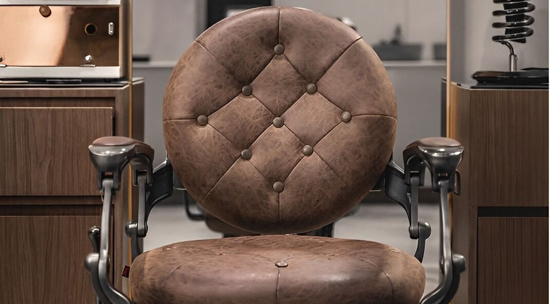 Luxurious leather barber chair at Scissors & Razors in Dubai, AE, offering comfort and style.