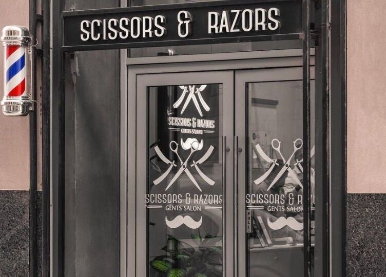 Scissors & Razors salon exterior with vintage barber pole in Dubai, AE.