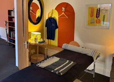 Relaxing massage room at Shep Sports Massage, London, England, GB, featuring modern decor and soothing lighting.