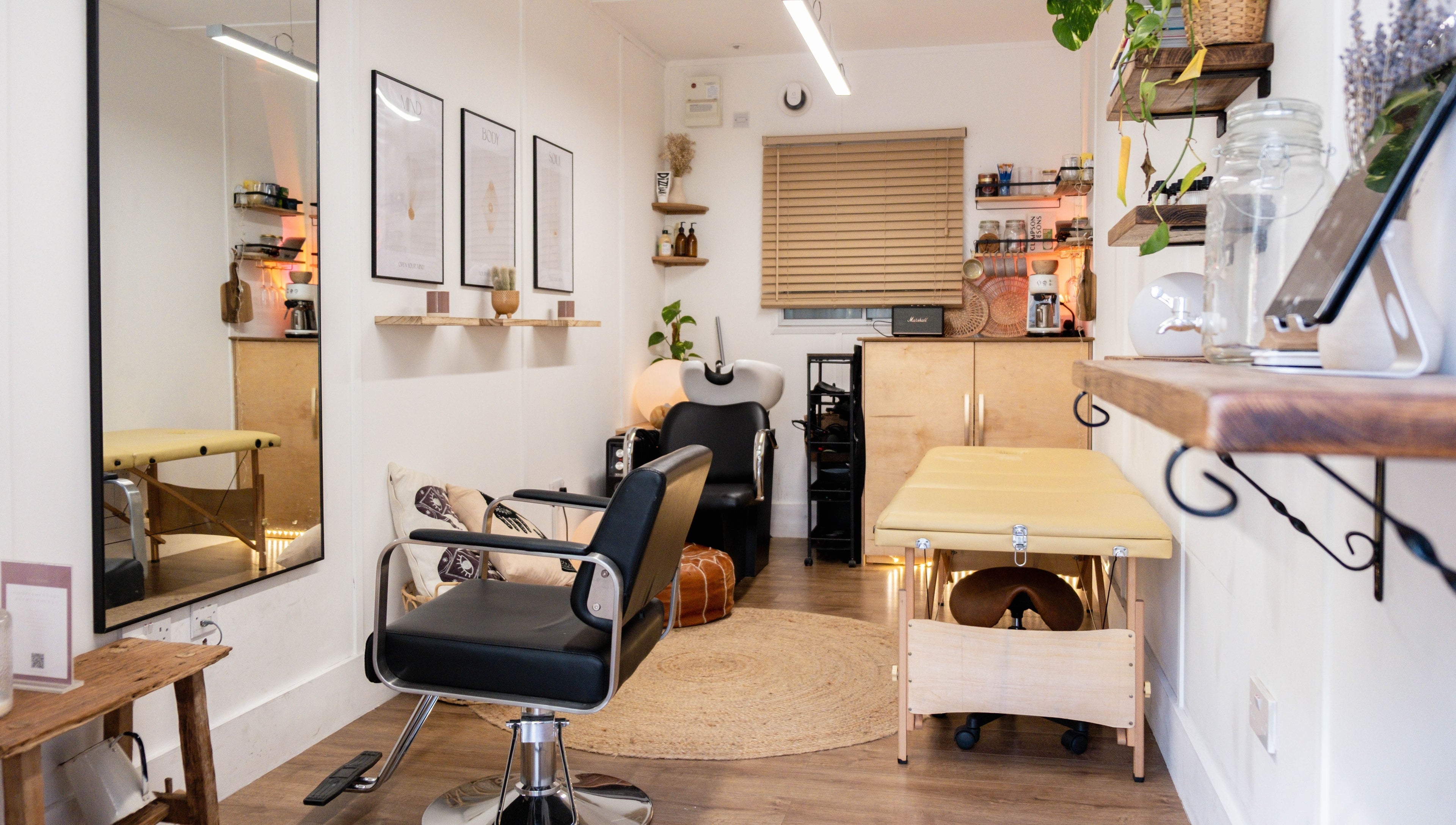 Elegant beauty room at Leia Loves, London, England, GB, showcasing a modern chair and massage table.